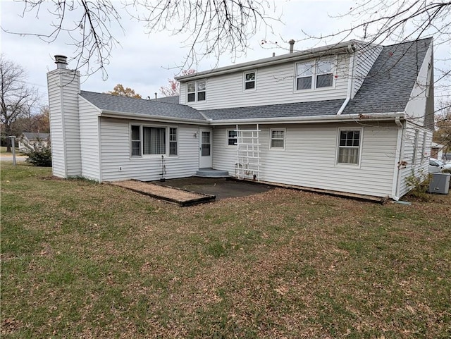 back of house with a yard and central AC unit