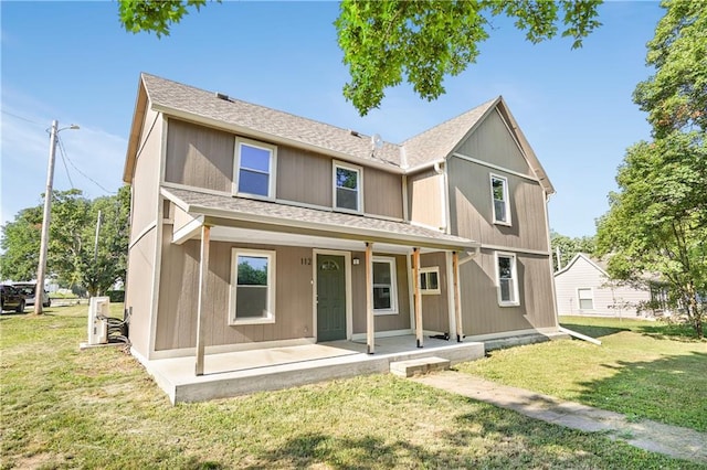 112 W Pine St, Drexel, MO 64742 - view of front facade with a porch, a front yard, and a shingled roof