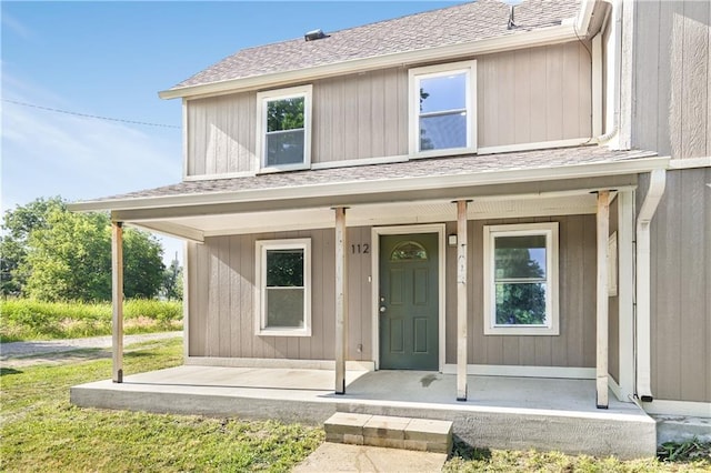 112 W Pine St, Drexel, MO 64742 - view of front facade featuring a porch and a shingled roof