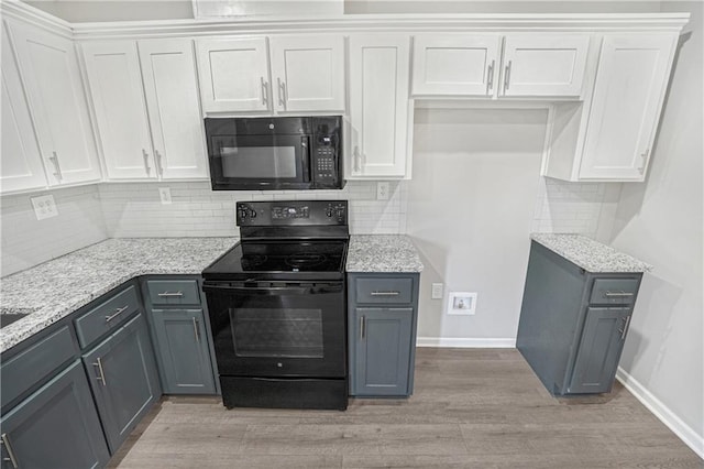 kitchen with black appliances, white cabinetry, gray cabinets, and light hardwood / wood-style flooring