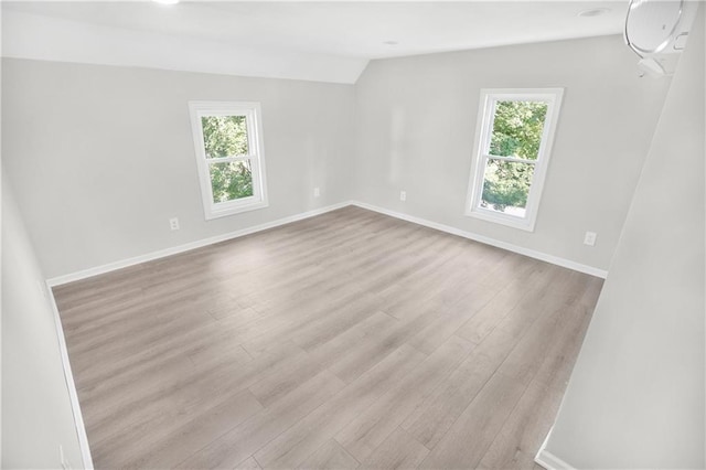 112 W Pine St, Drexel, MO 64742 - empty room featuring wood finished floors, vaulted ceiling, and baseboards