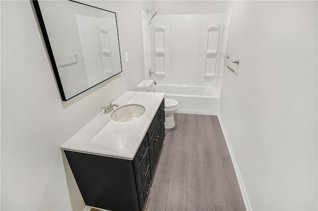 full bathroom with toilet, vanity, hardwood / wood-style flooring, and  shower combination