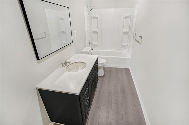 112 W Pine St, Drexel, MO 64742 - bathroom with toilet, wood finished floors, vanity, baseboards, and bathing tub / shower combination