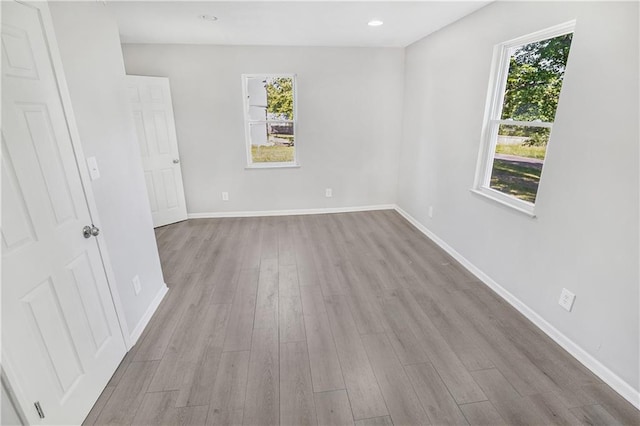 empty room with light hardwood / wood-style flooring