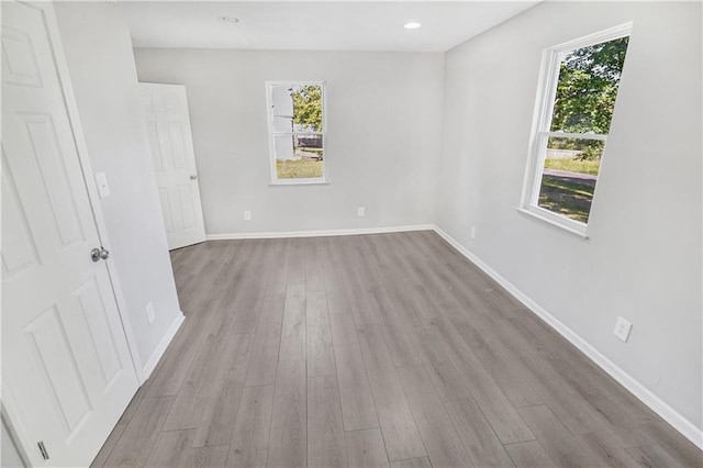 112 W Pine St, Drexel, MO 64742 - unfurnished room with wood finished floors, plenty of natural light, baseboards, and recessed lighting
