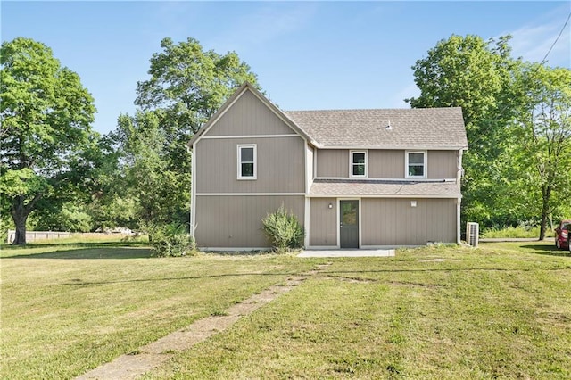112 W Pine St, Drexel, MO 64742 - rear view of house with roof with shingles, a yard, and a patio area