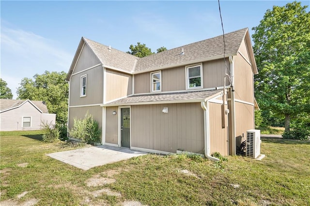 back of house with a lawn and ac unit