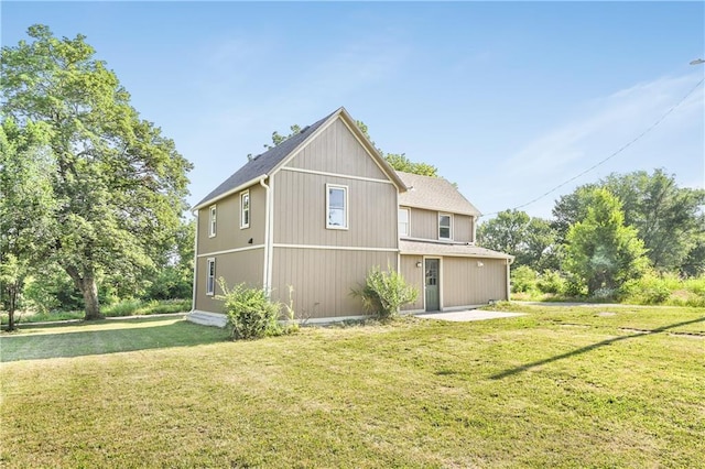 112 W Pine St, Drexel, MO 64742 - rear view of property featuring a yard