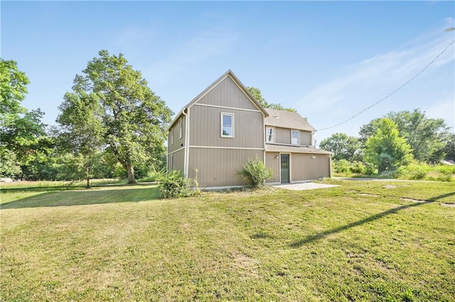 rear view of house featuring a lawn