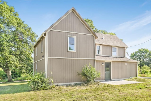 112 W Pine St, Drexel, MO 64742 - rear view of house with a lawn, a patio, and a shingled roof