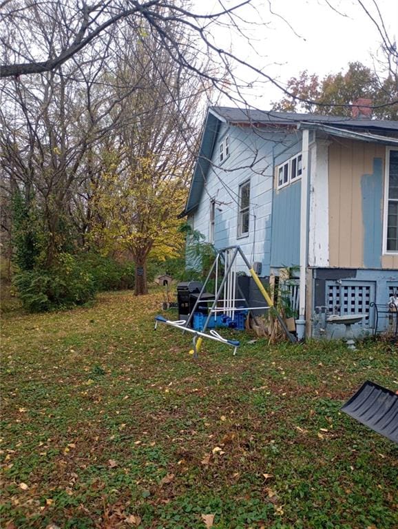 back of property featuring a lawn