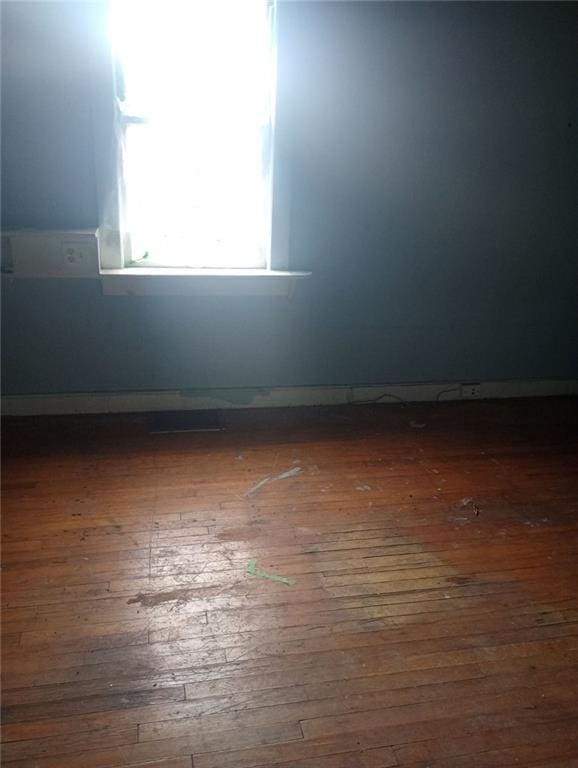 spare room featuring dark wood-type flooring