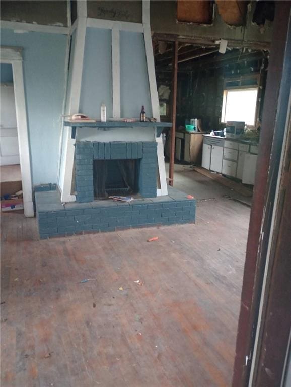 unfurnished living room with a fireplace and hardwood / wood-style flooring