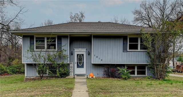 split foyer home with a front lawn