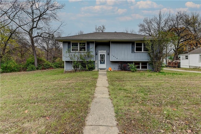 raised ranch with a front lawn