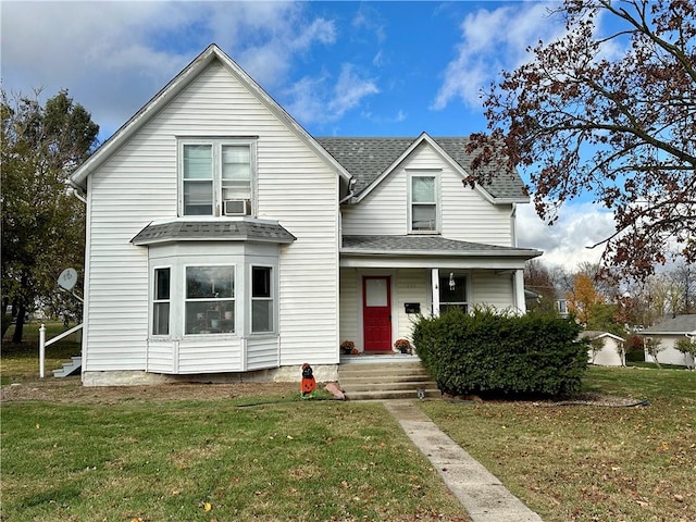 view of front of home featuring cooling unit and a front lawn