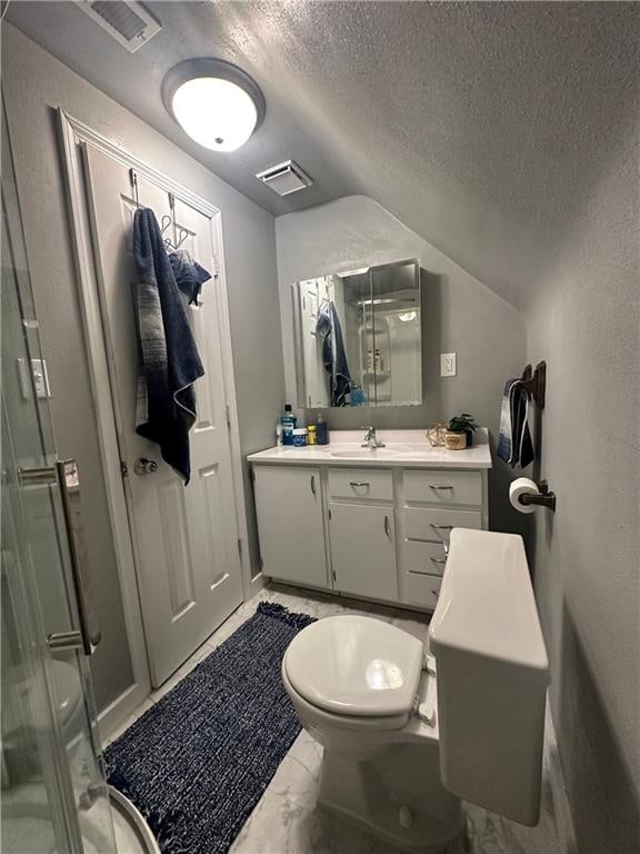 bathroom with lofted ceiling, toilet, a textured ceiling, vanity, and a shower with shower door