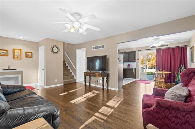 living room featuring ceiling fan and dark wood-type flooring