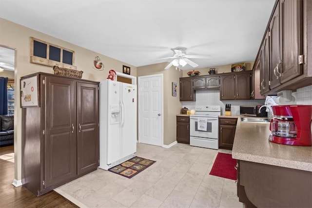 kitchen featuring decorative backsplash, dark brown cabinets, white appliances, ceiling fan, and sink