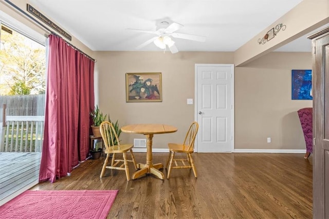 dining room with ceiling fan and dark wood-type flooring