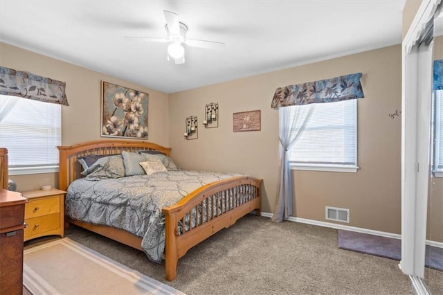 bedroom with carpet floors, multiple windows, and ceiling fan