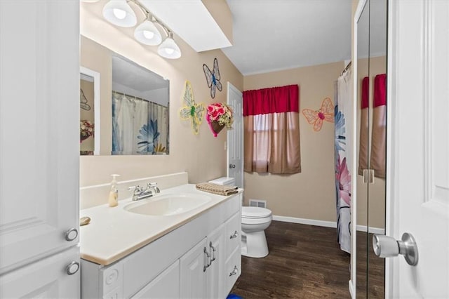 bathroom featuring hardwood / wood-style floors, vanity, and toilet