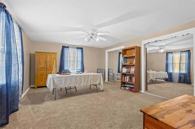 carpeted bedroom featuring multiple windows and ceiling fan