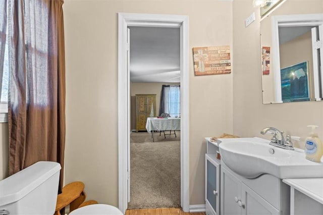 bathroom with vanity, toilet, and wood-type flooring