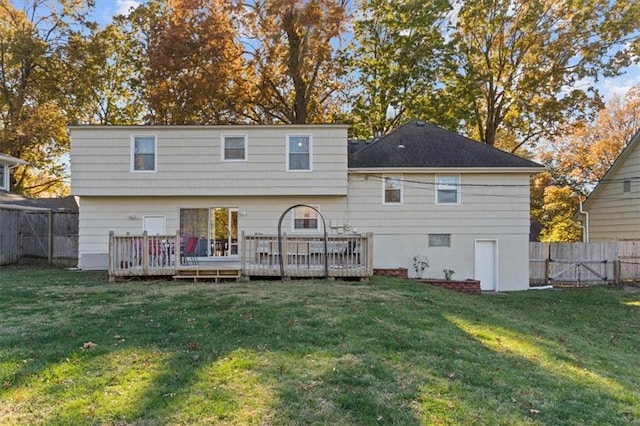 back of house with a wooden deck and a lawn