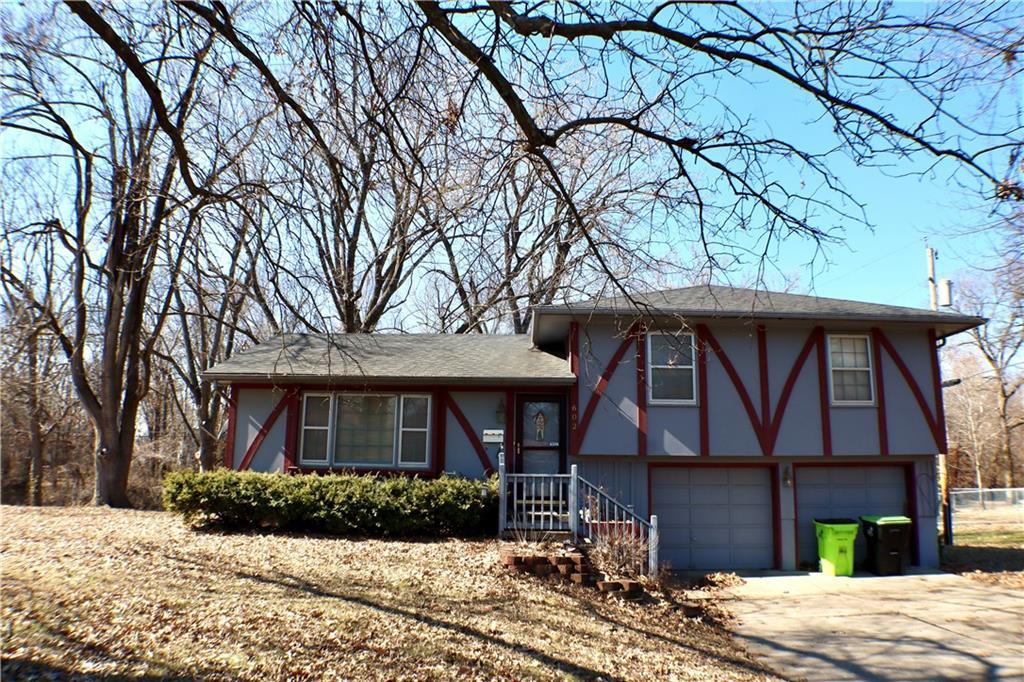 view of front of property with a garage, concrete driveway, and stucco siding