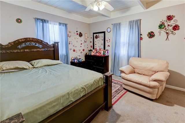 bedroom featuring beamed ceiling, carpet floors, and ceiling fan