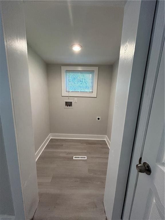 washroom featuring hookup for a washing machine and light hardwood / wood-style floors