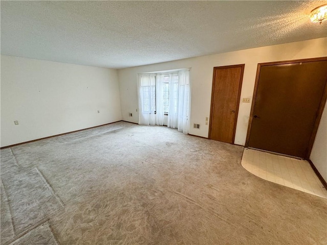 unfurnished bedroom with multiple closets, carpet, and a textured ceiling