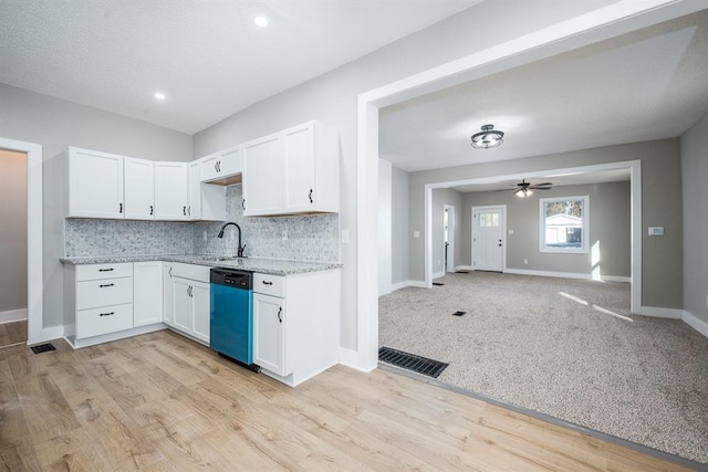 kitchen featuring light hardwood / wood-style floors, ceiling fan, white cabinetry, and dishwasher