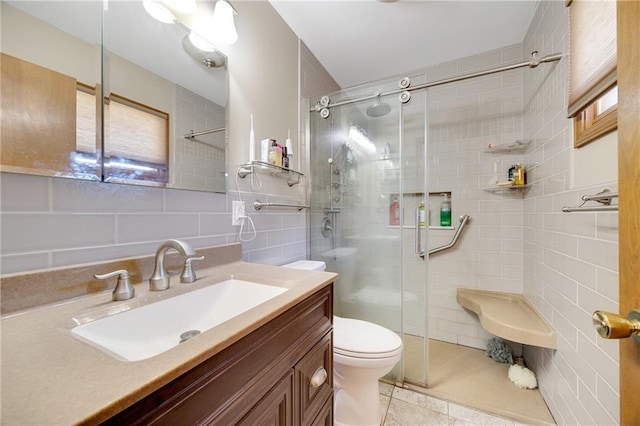 bathroom with tile patterned floors, an enclosed shower, and tile walls