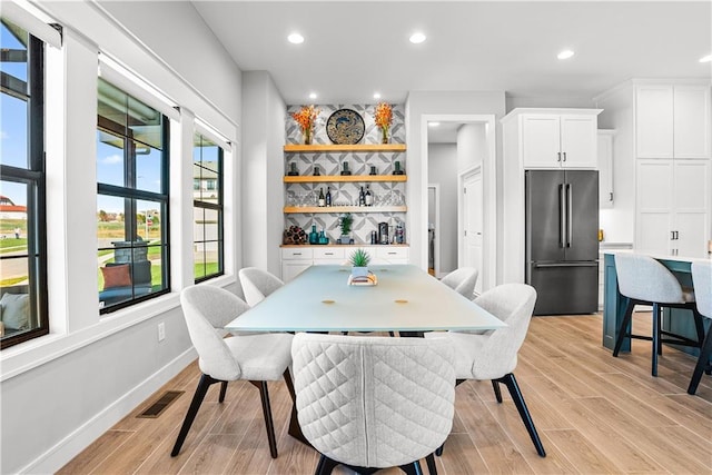 dining space with light hardwood / wood-style floors