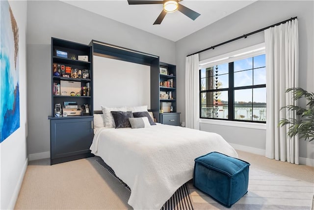 bedroom with light carpet and ceiling fan