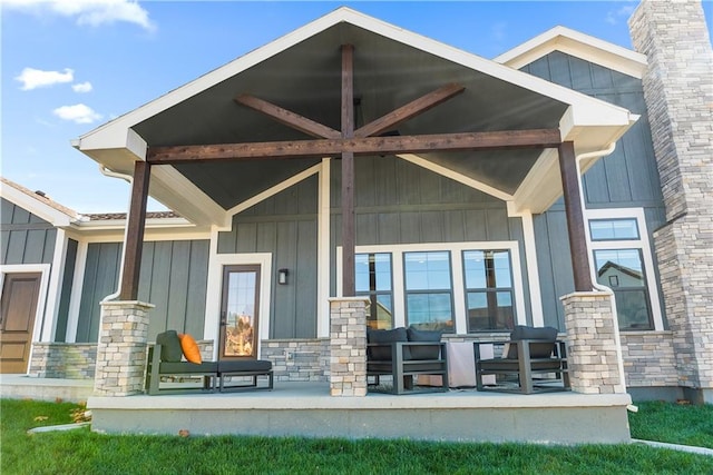 rear view of property featuring covered porch