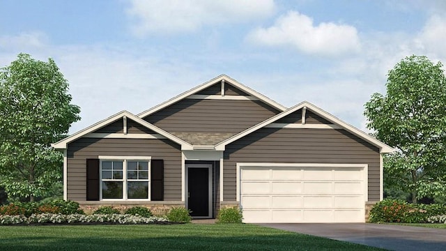 view of front of property with a garage and a front yard