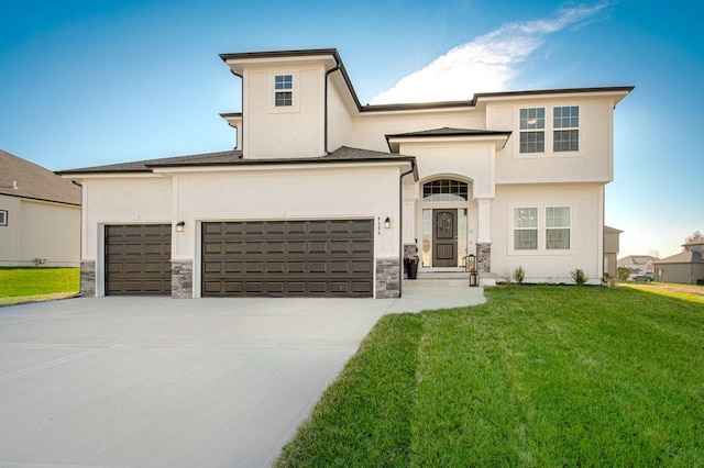 view of front of house featuring a front yard, concrete driveway, stone siding, and stucco siding