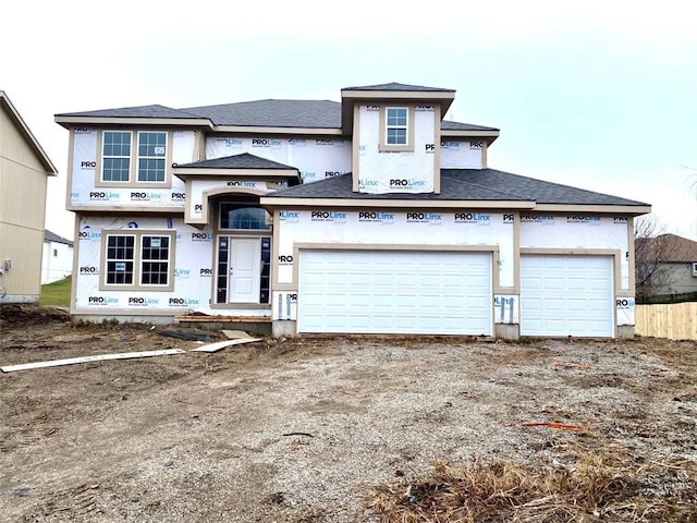 property in mid-construction with a garage, dirt driveway, and stucco siding