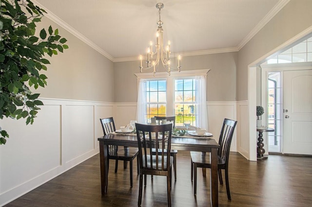 dining room featuring a wainscoted wall, an inviting chandelier, dark wood-type flooring, and ornamental molding