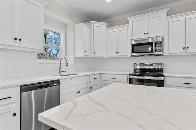 kitchen featuring a sink, appliances with stainless steel finishes, white cabinets, and crown molding