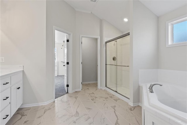 full bath with a garden tub, marble finish floor, a stall shower, baseboards, and vaulted ceiling