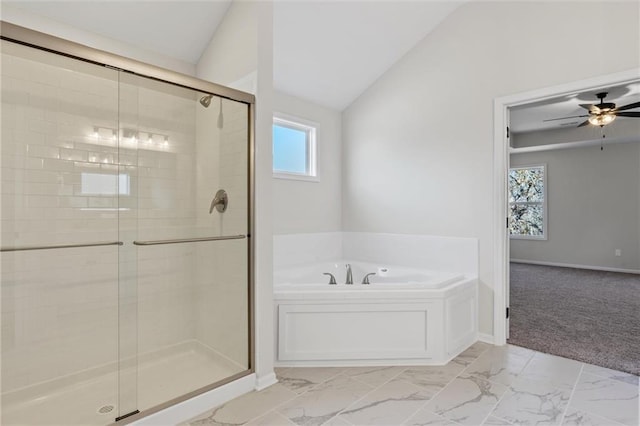 bathroom featuring vaulted ceiling, a garden tub, marble finish floor, and a stall shower