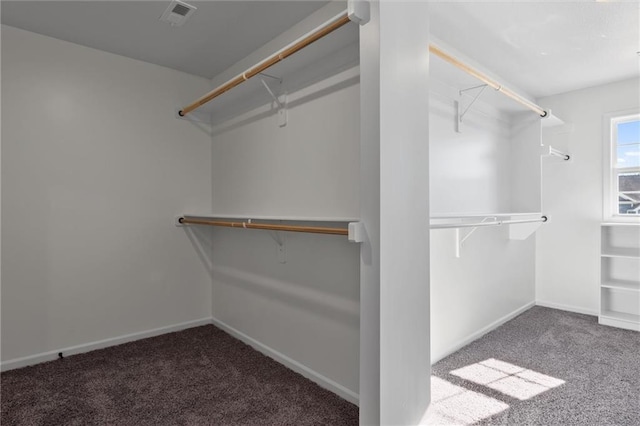 walk in closet featuring carpet flooring and visible vents