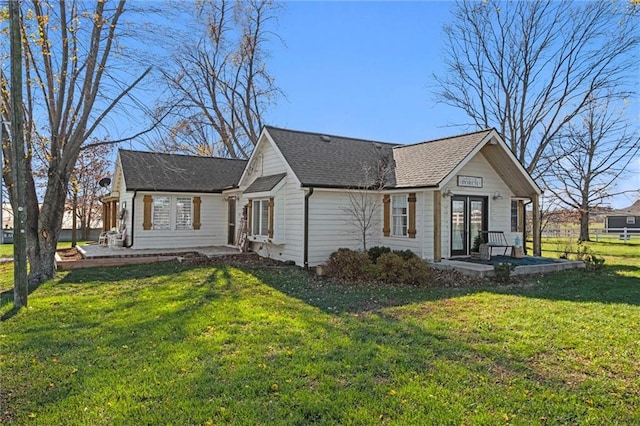 view of side of home with a patio area, a yard, and french doors