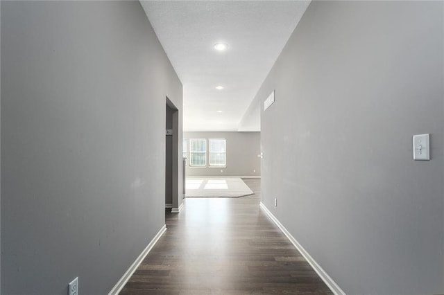 hallway with dark hardwood / wood-style floors