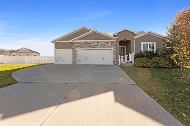 view of front of house featuring a front yard and a garage