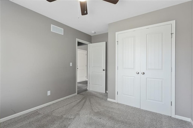 unfurnished bedroom featuring carpet flooring, ceiling fan, and a closet